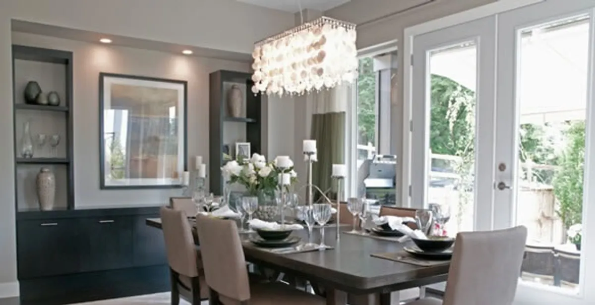 Elegant dining room chandelier installation above table in Sarasota, FL