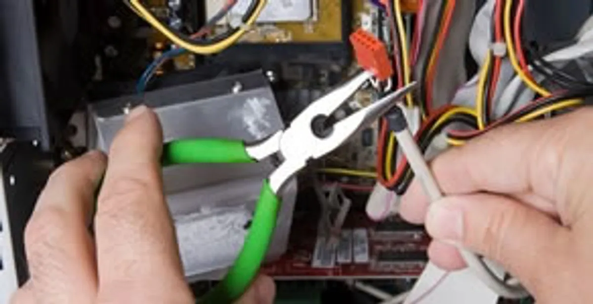 Licensed electrical contractor performing electrical repair with tools in Bradenton, FL