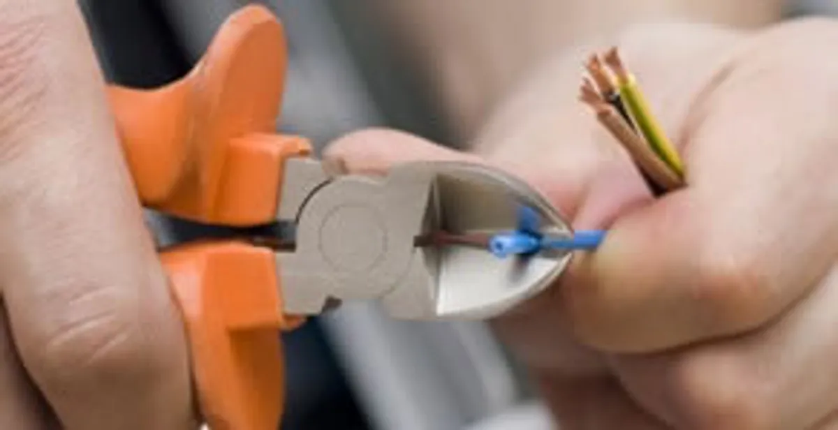 professional electrical services showing precise wire cutting by licensed electricians in Sarasota, FL